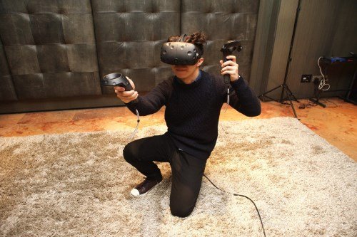 HTC Vive, also launched this year, is designed to allow the user to stand up and move in a range of a small room, while interacting more naturally with the included rods.